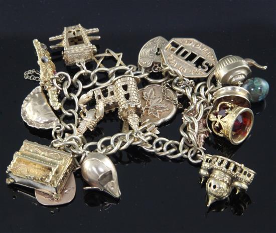 A 9ct gold charm bracelet hung with seventeen assorted charms, gross 67 grams.